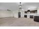 Open-concept living area featuring a kitchen, dining area, and stylish wood-look tile flooring at 216 Miles Ct, Davenport, FL 33837