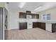 Well-lit kitchen features stainless steel refrigerator, dark cabinets, and white marble countertops at 216 Miles Ct, Davenport, FL 33837