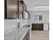 Modern kitchen features white marble countertops, subway tile backsplash, and stainless steel appliances at 216 Miles Ct, Davenport, FL 33837