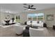 Bright living area featuring wood-look tile flooring, a ceiling fan, and a sliding glass door to the backyard at 216 Miles Ct, Davenport, FL 33837