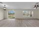 Bright living area features wood-look tile flooring, a ceiling fan, and a sliding glass door to the backyard at 216 Miles Ct, Davenport, FL 33837