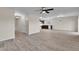 Open-concept living area features stylish wood-look tile flooring and modern light fixtures at 216 Miles Ct, Davenport, FL 33837