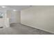 Upstairs loft features neutral carpet and paint with a window for natural light at 216 Miles Ct, Davenport, FL 33837