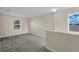 Upstairs loft with windows, neutral carpet, and paint, creating a versatile living space at 216 Miles Ct, Davenport, FL 33837
