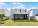 Well-maintained backyard with a covered patio, lawn, and privacy fence, perfect for outdoor enjoyment at 2237 Wood Stork Ln, St Cloud, FL 34771
