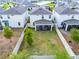 Aerial view of the backyard with a covered patio and fenced yard with healthy green grass at 2237 Wood Stork Ln, St Cloud, FL 34771