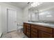Bathroom features a double sink vanity with cherry wood cabinets, tile flooring, and a toilet at 2237 Wood Stork Ln, St Cloud, FL 34771