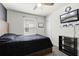 Bedroom with ceiling fan, window, and wall mounted TV at 2237 Wood Stork Ln, St Cloud, FL 34771