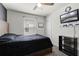 Bedroom with ceiling fan, window, and wall mounted TV at 2237 Wood Stork Ln, St Cloud, FL 34771