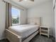 Comfortable bedroom with a bed, a nightstand, and a window at 2237 Wood Stork Ln, St Cloud, FL 34771