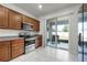 Bright kitchen featuring stainless steel appliances, wood cabinets, and sliding glass doors to the patio at 2237 Wood Stork Ln, St Cloud, FL 34771