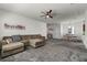 Spacious living room with neutral walls and carpet flooring that flows into the dining area at 2237 Wood Stork Ln, St Cloud, FL 34771