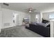 Carpeted living area with a cozy seating arrangement and access to additional rooms at 2237 Wood Stork Ln, St Cloud, FL 34771