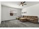 Cozy living room with a large sectional sofa, neutral paint, and plush carpet at 2237 Wood Stork Ln, St Cloud, FL 34771