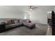 Second living room space featuring a large sectional and a TV at 2237 Wood Stork Ln, St Cloud, FL 34771
