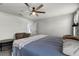Bright main bedroom featuring a ceiling fan, tv, ensuite bathroom and rustic wood furniture at 2237 Wood Stork Ln, St Cloud, FL 34771
