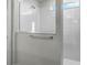 Walk in shower with white tile and a frameless glass enclosure at 2237 Wood Stork Ln, St Cloud, FL 34771