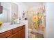 Bathroom with a yellow floral shower curtain, and vanity with updated fixtures and decor at 2289 Aloe Aly, Apopka, FL 32703