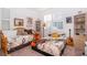 Cozy bedroom featuring two beds with music-themed blankets, a large window and shelving units at 2289 Aloe Aly, Apopka, FL 32703