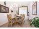 Elegant dining room with a glass-topped table, ornate chairs, and tasteful decor with bright natural light at 2289 Aloe Aly, Apopka, FL 32703