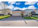 Charming home with a well-maintained lawn, brick driveway, and a two-car garage at 2289 Aloe Aly, Apopka, FL 32703