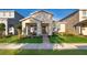 Charming single Gathering home featuring a neatly maintained lawn, landscaping, and cozy front porch with rocking chairs at 2289 Aloe Aly, Apopka, FL 32703