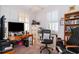 Home office with a large desk, computer, comfortable chair, shelving, and bright natural light at 2289 Aloe Aly, Apopka, FL 32703