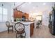 Bright kitchen with wood cabinets, stainless steel appliances, breakfast bar, and views into the adjacent dining area at 2289 Aloe Aly, Apopka, FL 32703