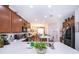 Spacious kitchen featuring white countertops, wood cabinets, stainless steel appliances, and an open layout to the dining area at 2289 Aloe Aly, Apopka, FL 32703