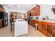 Large kitchen featuring wood cabinets, stainless steel appliances, breakfast bar, and an open layout to the living spaces at 2289 Aloe Aly, Apopka, FL 32703