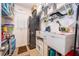Laundry room with modern appliances, storage shelves, and a utility sink at 2289 Aloe Aly, Apopka, FL 32703