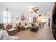 Open-concept living room seamlessly connected to the kitchen, featuring a ceiling fan and comfortable seating at 2289 Aloe Aly, Apopka, FL 32703