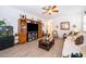 Comfortable living room with a ceiling fan, decorative entertainment center, and seamless transition to other spaces at 2289 Aloe Aly, Apopka, FL 32703