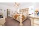 Spacious main bedroom featuring a decorative bed frame, carpeted floor, and plenty of natural light at 2289 Aloe Aly, Apopka, FL 32703
