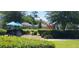 Outdoor picnic area with tables, grill, and verdant landscaping creating a relaxing gathering space at 2289 Aloe Aly, Apopka, FL 32703