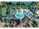 Aerial view of community amenities, featuring pools, a lazy river, and a lake at 2412 Tanger Dr, Kissimmee, FL 34747