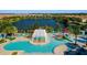 Stunning aerial view of community pools, waterslides, lounge areas, and lush landscaping at 2412 Tanger Dr, Kissimmee, FL 34747