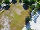 Aerial view of a community field with soccer goals, sand pit, palm trees, and sidewalk at 2412 Tanger Dr, Kissimmee, FL 34747