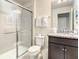 Spotless bathroom features tiled shower, granite counter tops, and ample storage space at 2412 Tanger Dr, Kissimmee, FL 34747
