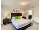 Comfortable bedroom with a neutral color scheme, ensuite bathroom, dark furniture, and stylish decor at 2412 Tanger Dr, Kissimmee, FL 34747