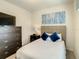 Comfortable bedroom featuring a queen bed, ample storage, and a calming atmosphere at 2412 Tanger Dr, Kissimmee, FL 34747