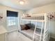 Bedroom features a bunk bed, window, and neutral color scheme at 2412 Tanger Dr, Kissimmee, FL 34747