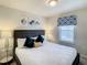 Bright bedroom with modern decor and comfortable bedding at 2412 Tanger Dr, Kissimmee, FL 34747