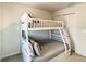 Cozy bedroom features a white bunk bed, ideal for or guests at 2412 Tanger Dr, Kissimmee, FL 34747