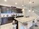 Modern kitchen featuring granite countertops, stainless steel appliances, and a center island with bar seating at 2412 Tanger Dr, Kissimmee, FL 34747