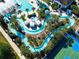 Aerial view of a winding lazy river, cabanas and the pool area at 2412 Tanger Dr, Kissimmee, FL 34747