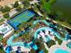 Aerial view of the community lazy river alongside a basketball court and lush landscaping at 2412 Tanger Dr, Kissimmee, FL 34747