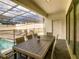 Relaxing outdoor space with a covered patio, dining table, and poolside loungers at 2412 Tanger Dr, Kissimmee, FL 34747