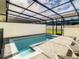Private backyard with screened-in pool and patio offers the perfect outdoor retreat at 2412 Tanger Dr, Kissimmee, FL 34747