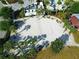 Aerial view of the beach volleyball court, surrounded by palm trees and tropical foliage at 2412 Tanger Dr, Kissimmee, FL 34747